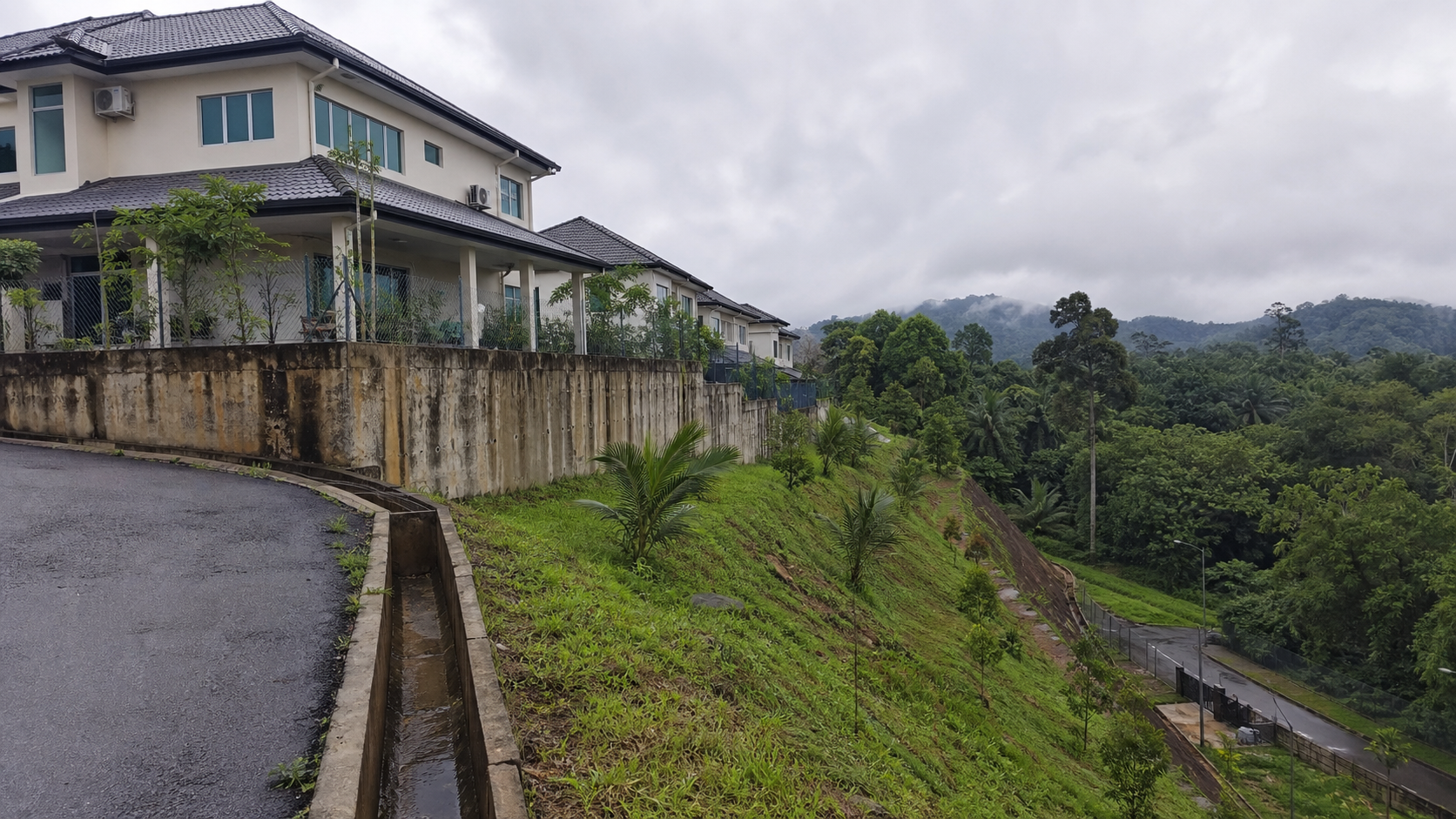 Hillside residential development context with drainage and slope-quality considerations.